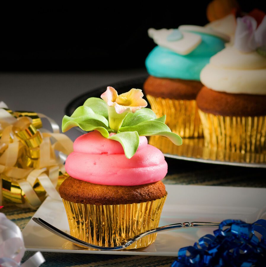 cupcake with red icing and fondant flower on top by frederick food photographer Jeff Behm Studios