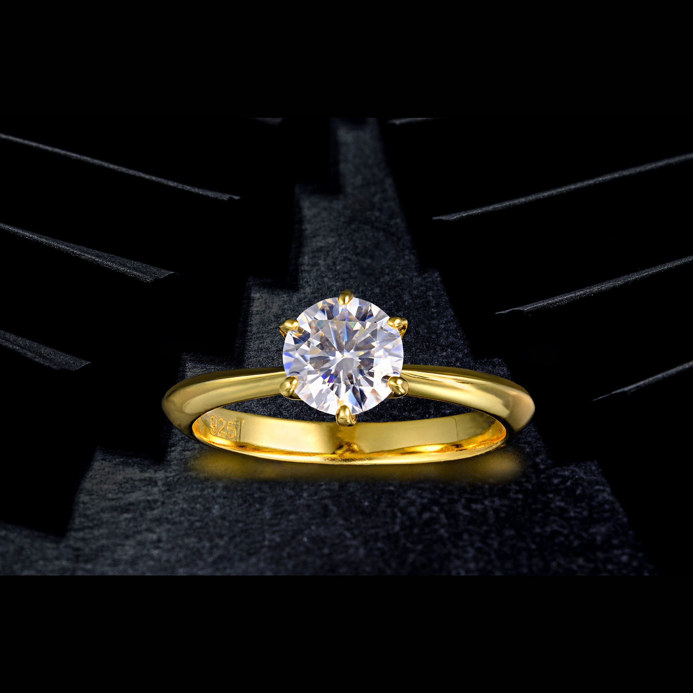 Gold ring with diamond on black texture background