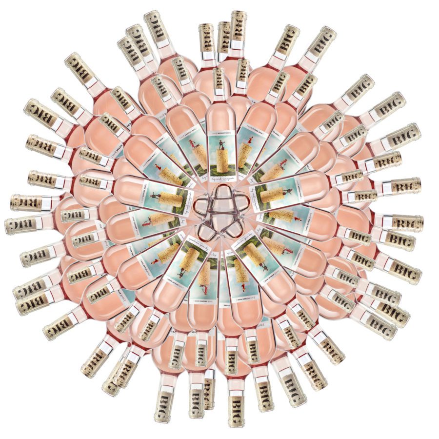 Arrangement of bottles of wine in a floral configuration, on white